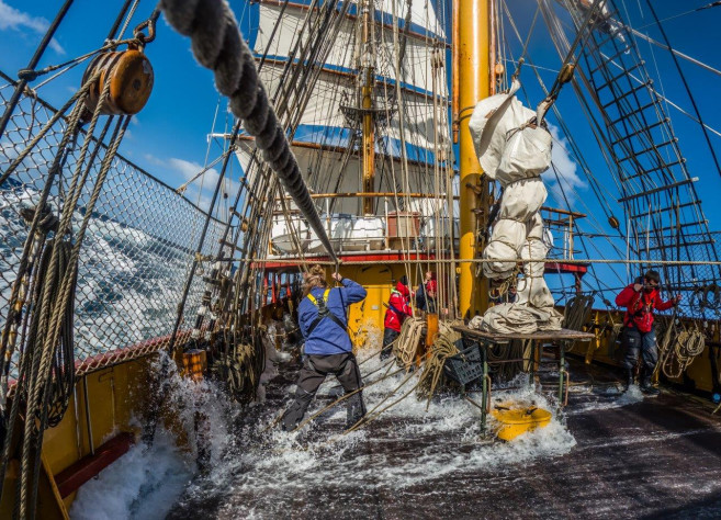 A shot of a tall ship under turbulent seas